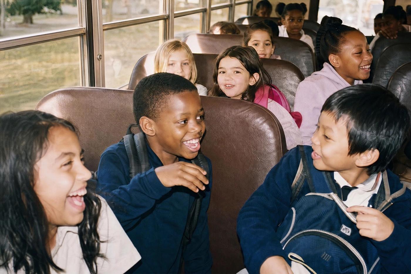 Children laughing on a school bus